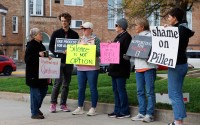 A group of demonstrators against using the McCook Work Ethic Camp prison as a federal detention center, hold signs outside the Red Willow County Courthouse in McCook, Neb., on Friday, Oct. 24, 2025.
 (Nikos Frazier / Omaha World-Herald via AP)