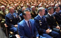 Defense Secretary Pete Hegseth (front left) and senior U.S. military leaders listen to President Donald Trump speak at Marine Corps Base Quantico in Virginia in 2025. 
(Evan Vucci / AP Photo)