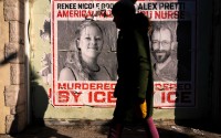 A woman walks by posters of Renee Good and Alex Pretti during a solidarity bike ride for Pretti, Saturday, Jan. 31, 2026, in Minneapolis.
 (Julia Demaree Nikhinson / AP Photo)