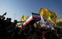 Mourners carry the coffin of an Iranian adviser draped in the Iranian flag during a group funeral for Iranian advisers and Popular Mobilization Forces fighters killed in airstrikes on bases belonging to Iraq's Popular Mobilization Forces, a coalition of predominantly Shiite militias that includes Iran-backed groups, in Mosul, Iraq, Wednesday, July 29, 2026.
 (Hadi Mizban / AP Photo)
