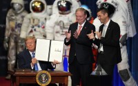 President Donald Trump holds up an order to create the U.S. Space Academy before a Congressional Space Medal of Honor ceremony at NASA's Johnson Space Center, Friday, Aug. 28, 2026, in Houston, as Kevin Hassett (center), director of the National Economic Council and NASA Administrator Jared Isaacman (right) look on.
(Karen Warren / AP Photo)