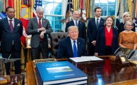 President Donald Trump winks as the members of the media depart the Oval Office of the White House as Essar Capital Director Prashant Ruia, from left: Energy Secretary Chris Wright, Commerce Secretary Howard Lutnick, John Jovanovic, chairman of the Export-Import Bank of the United States, Iowa Attorney General Brenna Bird, Mariannette Miller-Meeks, R-Iowa., and Rep. Ashley Hinson, R-Iowa, look on, Monday, Sept. 28, 2026, in Washington. 
(Alex Brandon / AP Photo)