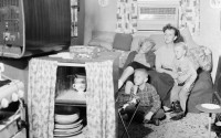 Watching the TV in their trailer house home at the U.S. Wheelus air base in Libya, about seven miles east of Tripoli on Feb. 19, 1959, are Mrs. Betty Wood, of Tampa, Florida, her son Phillip, eldest daughter Bonnie Jo, and the youngest daughter Cheryl Ann. 
(Jim Pringle / AP Photo)