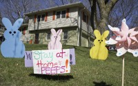A yard sign in Omaha, Friday, April 10, 2020, urges people to stay at home. Social distancing and staying at home are some of the measures to combat the coronavirus outbreak. (AP)
