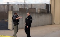 Two federal officers stand outside the Cedar Rapids ICE Field Office during a rally on Tuesday, Sept. 2, 2025, in Cedar Rapids, Iowa. Neither the Cedar Rapids Police Department nor the Linn County Sheriff's Office has a 287(g) agreement with Immigration and Customs Enforcement. However, the Iowa State Patrol does. 
(Naomi Delkamiller / The Midwest Newsroom)