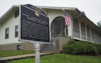 A Nebraska state historical marker acknowledging the former hospital, which will soon reopen as the Dr. Susan La Flesche Picotte Center in Walthill. Dr. Susan La Flesche Picotte was America's first Native American doctor, who then came back to Nebraska and became the sprawling Omaha Reservation’s first medical doctor. She built this hospital, the first of its kind in America. 
(Jerry L Mennenga / Flatwater Free Press)
