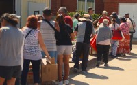 Grand Island-area residents line up at the Messiah Evangelical Lutheran Church Free Food & Many Blessings food distribution on Sunday, July 12. 
(Josh Salmon / Flatwater Free Press)
