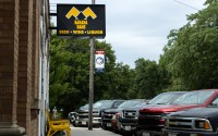 Cars and trucks line the street outside of the Banana Rams bar in Hordville. In eight years, the small business has grown in regional popularity and routinely attracts a crowd of locals from throughout Hamilton County. 
(Pierce Gentry / Flatwater Free Press)