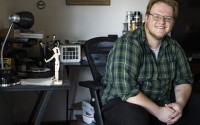Seth Harlan poses for a portrait at his desk in his Lincoln apartment. Harlan has spent all of his adult life living in apartments. 
(Lily Smith / Flatwater Free Press)
