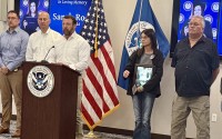 U.S. Homeland Security Secretary Markwayne Mullin is flanked by Republican U.S. Sen. Pete Ricketts (left) and the parents of Sarah Root, Michelle and Scott (on the right). Their daughter Sarah was killed in a 2016 car crash involving an undocumented migrant. Mullin was in Omaha last Monday for two unrelated events. The other was to discuss his department’s progress on streamlining federal disaster aid to communities. 
(Cindy Gonzalez / Nebraska Examiner)