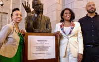 A bust sculpture of Malcolm X was unveiled at his May 2024 induction into the Nebraska Hall of Fame. The art was designed by Lincoln artist Nathan Murray, who is shown here with Malcolm X’s daughter Ilyasah Shabazz (right of the bust) and JoAnna LeFlore-Ejike, executive director of the Malcolm X Memorial Foundation. The bust’s permanent spot is in a hallway of the State Capitol with other Hall of Fame busts.
 (Cindy Gonzalez / Nebraska Examiner)