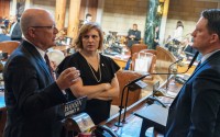 Speaker John Arch of La Vista and State Sen. Machaela Cavanaugh of Omaha meet on the floor of the Nebraska Legislature on Jan. 15, 2025. 
(Zach Wendling / Nebraska Examiner)