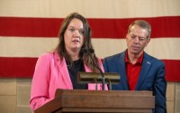 Nebraska Tourism Commission Director Jenn Gjerde (left) with Nebraska Gov. Jim Pillen. 
(Zach Wendling / Nebraska Examiner)