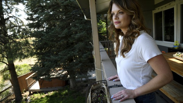 Sonia Moran looks at a meadow owned by The Rock church from her patio in Castle Rock, Colo., on Friday, July 12, 2024. The church plans were to develop affordable housing on its property, drawing the ire of some of its neighbors, including Moran. 
(Thomas Peipert / AP Photo)