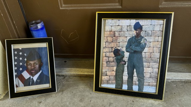 Candles and framed photos of Roger Fortson, a U.S. Air Force senior airman who was fatally shot by a Fla. sheriff's deputy on May 3, 2024, sit in the doorway of the apartment where he was killed in Fort Walton Beach, Fla., on Aug. 23. 
(Kate Payne / AP Photo)
