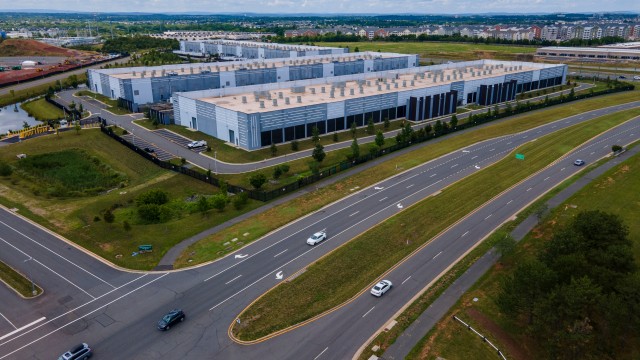 Cars drive past data centers that house computer servers and hardware required to support modern internet use, such as artificial intelligence, in Ashburn, Virginia, July 16, 2023. 
(Ted Shaffrey / AP Photo)