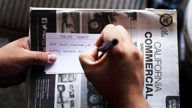 A student truck driver makes flash cards for his commercial driver's license exam while taking a class in Calif., Nov. 15, 2021. 
(Jae C. Hong / AP Photo)