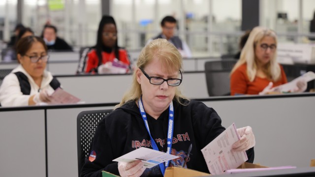 A worker examines ballots at the L.A. County Ballot Processing Center Nov. 4, 2025, in City of Industry, Calif.
(Ethan Swope / AP Photo)