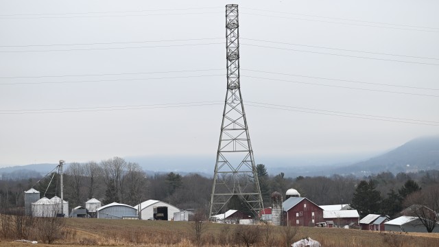 A 235-kilovolt power line towers over farm buildings near where the local power utility plans to build a 500-kilovolt power line on towers as tall as 240 feet, March 4, 2026, in Sugarloaf, Pa. 
(Marc Levy / AP Photo)