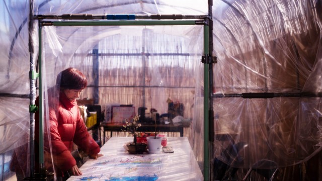 Tomoko Kobayashi looks at a color-coded map of radiation levels created by local residents during an interview near a radiation monitoring lab in Odaka, Friday, Feb. 13, 2026. 
(Louise Delmotte / AP Photo)