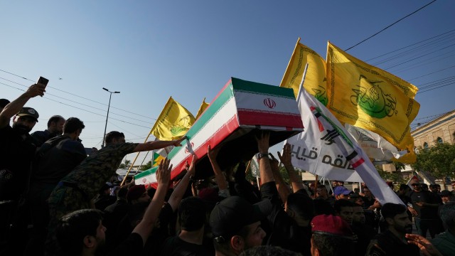 Mourners carry the coffin of an Iranian adviser draped in the Iranian flag during a group funeral for Iranian advisers and Popular Mobilization Forces fighters killed in airstrikes on bases belonging to Iraq's Popular Mobilization Forces, a coalition of predominantly Shiite militias that includes Iran-backed groups, in Mosul, Iraq, Wednesday, July 29, 2026.
(Hadi Mizban / AP Photo)