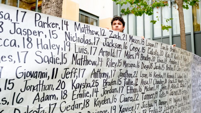 Dawson Kelly holds a banner with names of young people who advocates say died as a result of social media at a protest outside the Ronald V. Dellums Federal Building and U.S. Courthouse on Tuesday, Aug. 18, 2026, in Oakland, Calif. 
(Noah Berger / AP Photo)