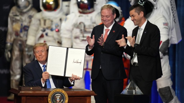 President Donald Trump holds up an order to create the U.S. Space Academy before a Congressional Space Medal of Honor ceremony at NASA's Johnson Space Center, Friday, Aug. 28, 2026, in Houston, as Kevin Hassett (center), director of the National Economic Council and NASA Administrator Jared Isaacman (right) look on.
(Karen Warren / AP Photo)