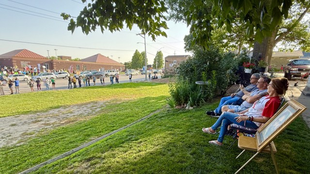 Ramped up immigration enforcement hits close to home with some Nebraskans. Sharon Boll, with boyfriend Lonnie Ortez to the left, and an image of Jesus Christ to the right, watched anti-ICE protesters from her lawn on June 10, following the immigration raid at Glenn Valley Foods in Omaha. 
(Cindy Gonzalez / Nebraska Examiner)
