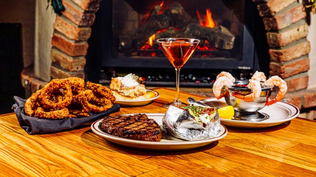 Everything we tried at The Drover during our Steak Town visit included (clockwise from left) onion rings, cinnamon toffee cheesecake, a Manhattan cocktail, shrimp cocktail, a loaded baked potato and a ribeye.
(Joshua Foo / Flatwater Free Press)