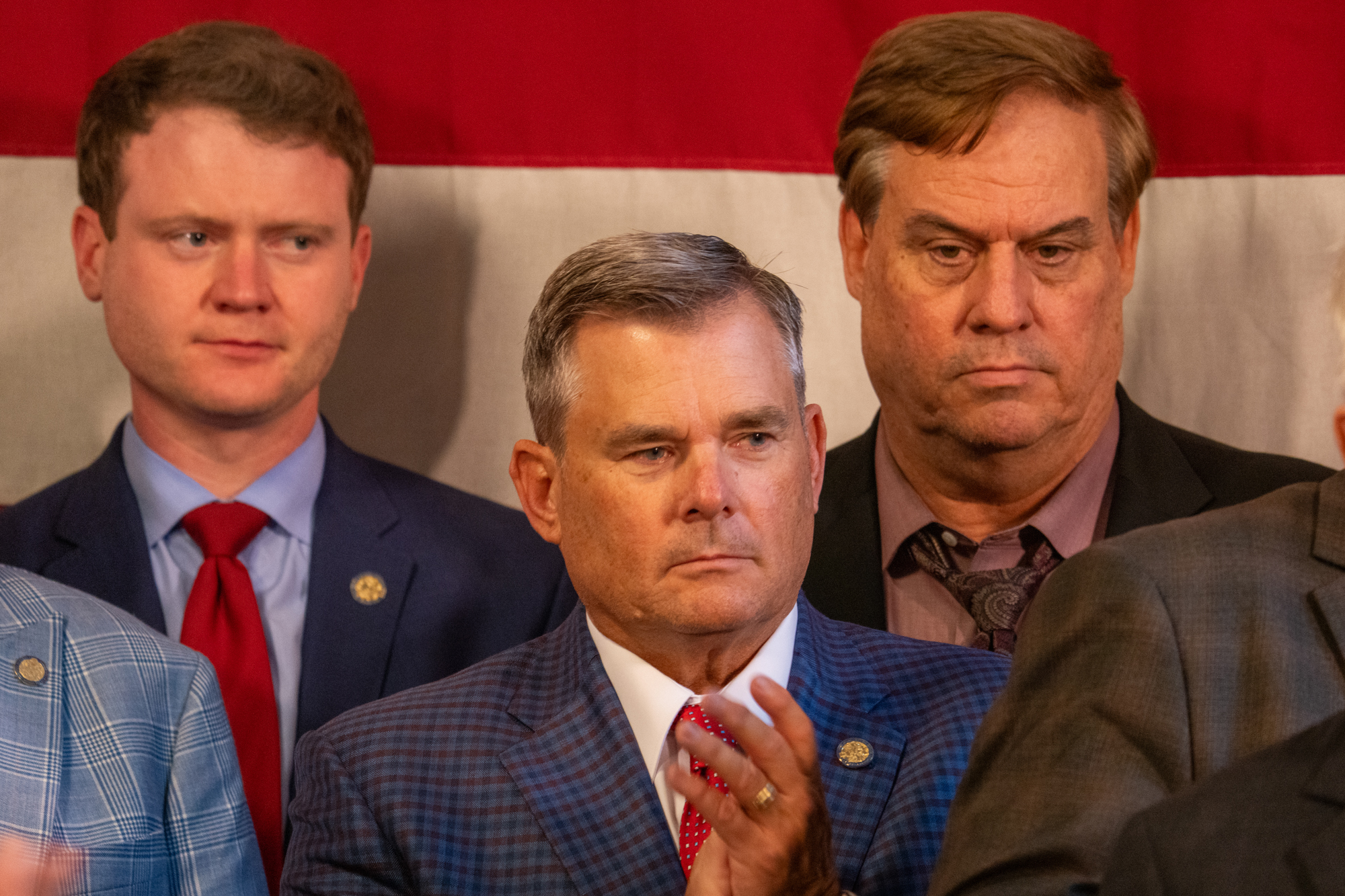 State Sen. Brad von Gillern of Elkhorn (center) flanked by State Sens. Beau Ballard of Lincoln and Mike McDonnell of Omaha on Aug. 20, 2024.<br />(Zach Wendling / Nebraska Examiner)